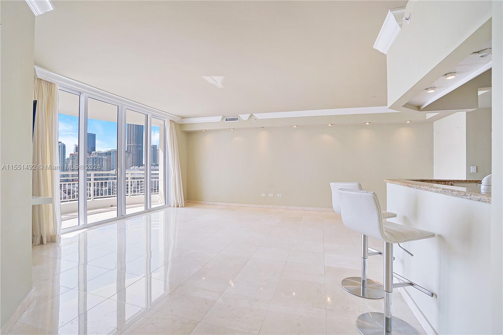 848 Brickell Key Drive, Unit 2003 Miami, FL 33131 - Photo 23 of 35 a view of an empty room with a window
