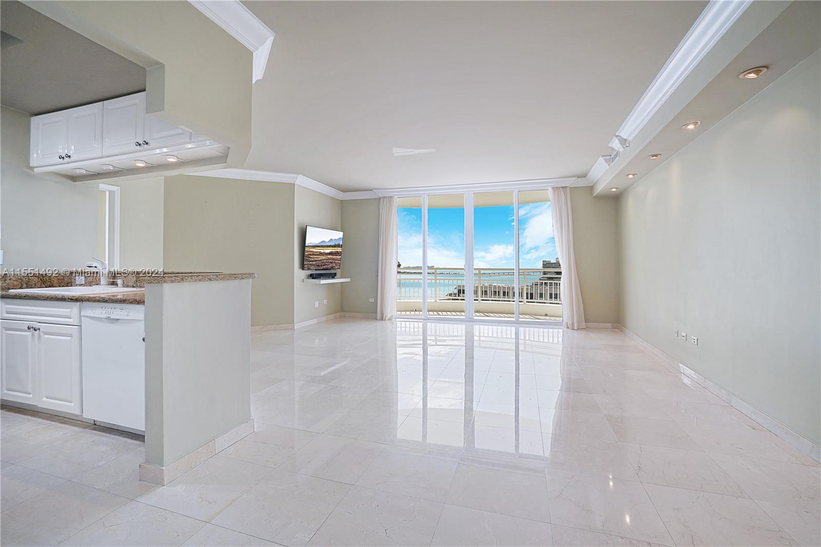 848 Brickell Key Drive, Unit 2003 Miami, FL 33131 - Photo 25 of 35 a kitchen with white cabinets and white appliances