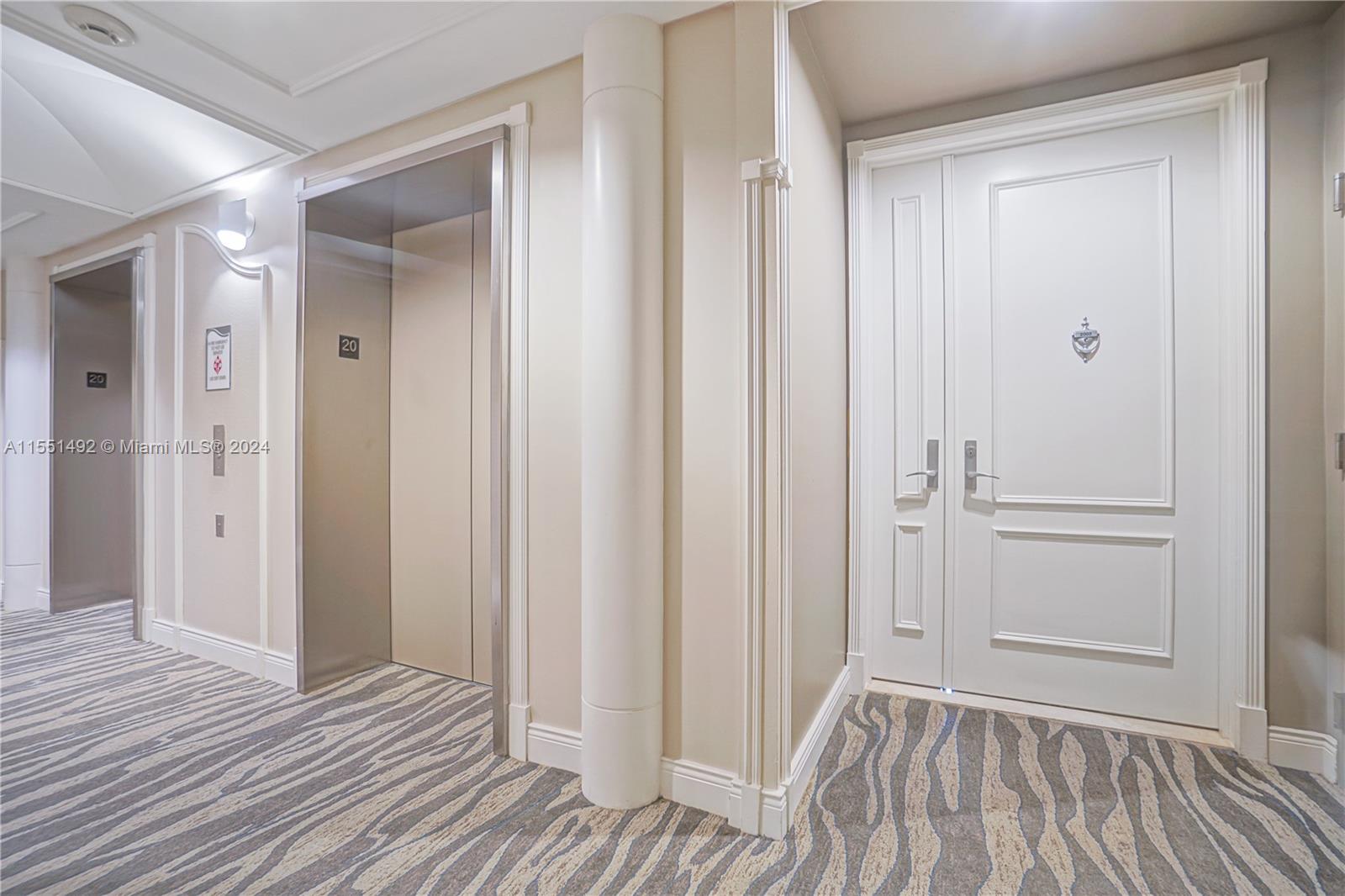 848 Brickell Key Drive, Unit 2003 Miami, FL 33131 - Photo 35 of 35 a view of a bathroom with wooden floor and white doors