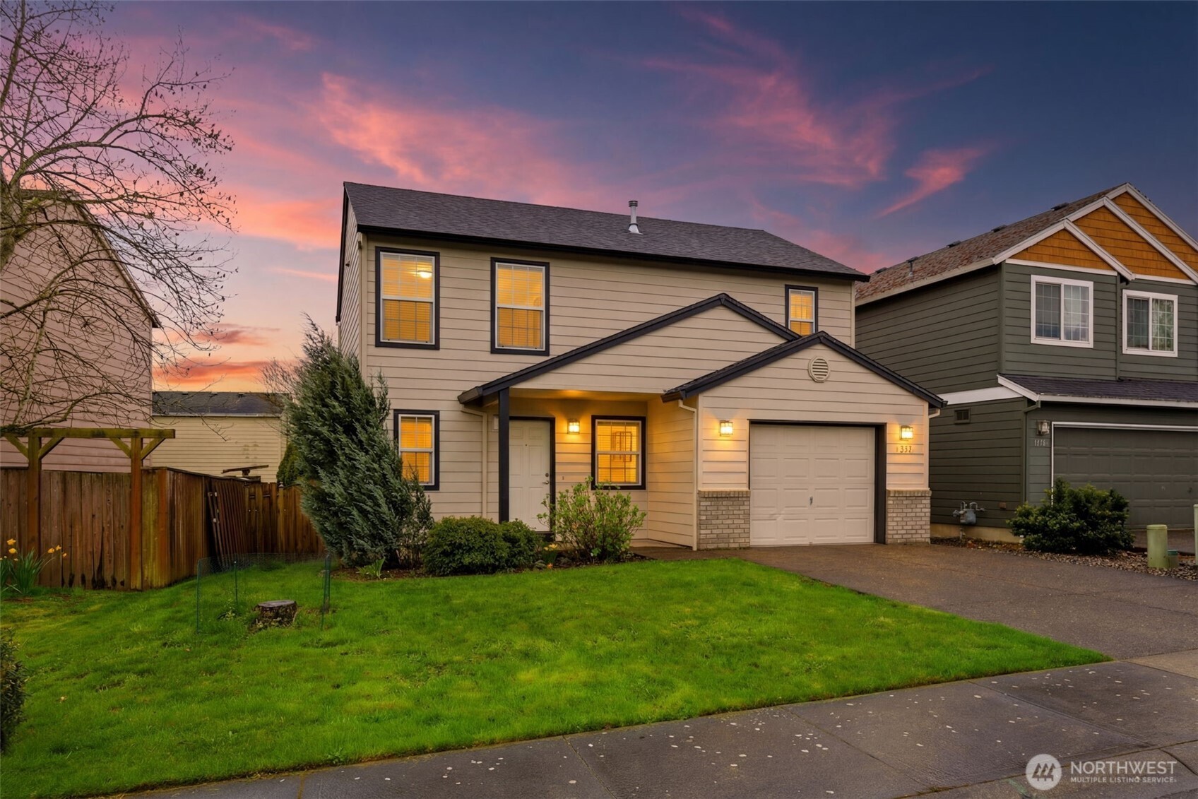 1205 Northeast 165th Way Ridgefield, WA 98642 - Photo 1 of 38 a front view of a house with a yard and garage