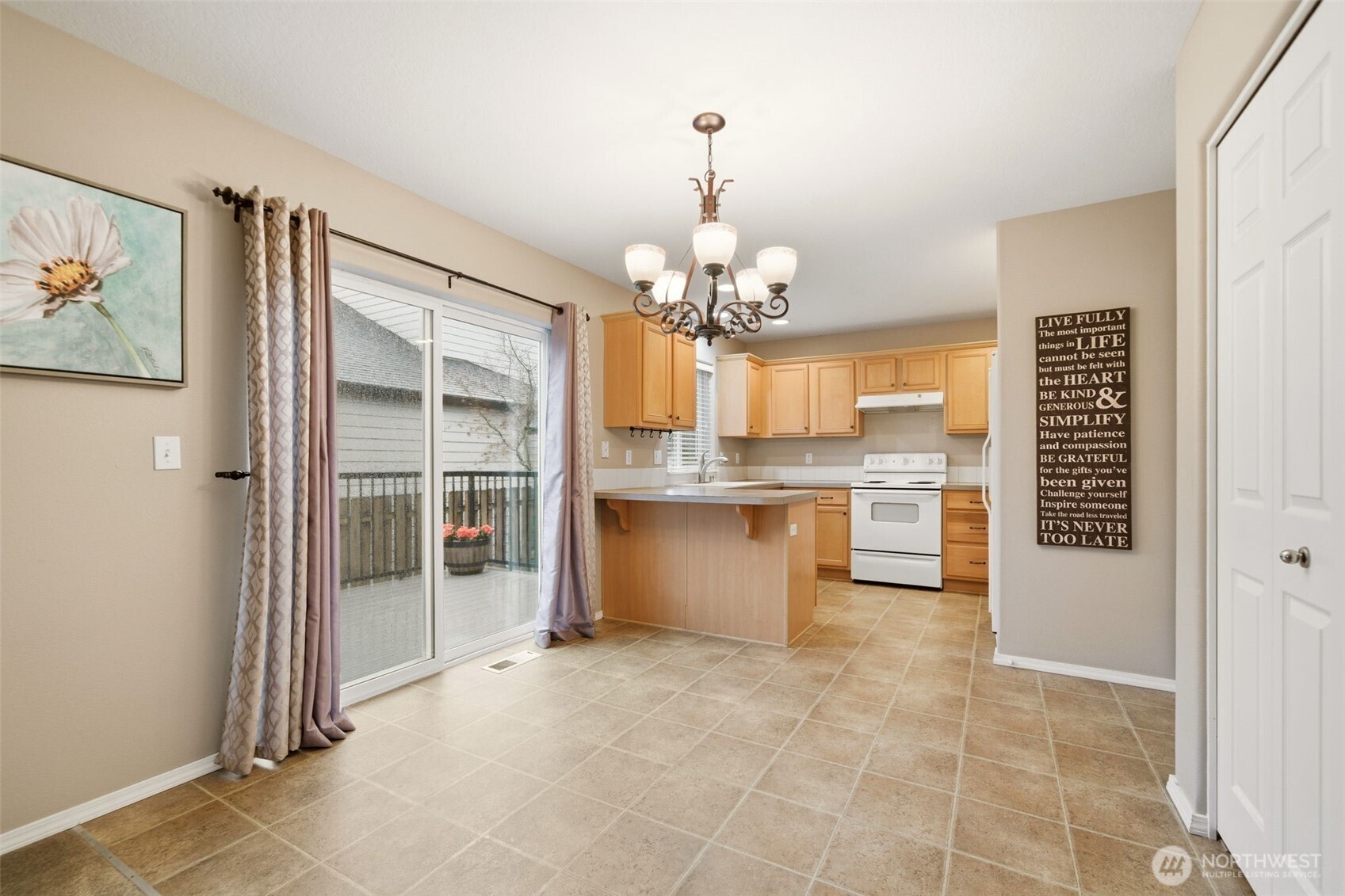 1205 Northeast 165th Way Ridgefield, WA 98642 - Photo 12 of 38 a view of a kitchen with granite countertop a refrigerator and a sink