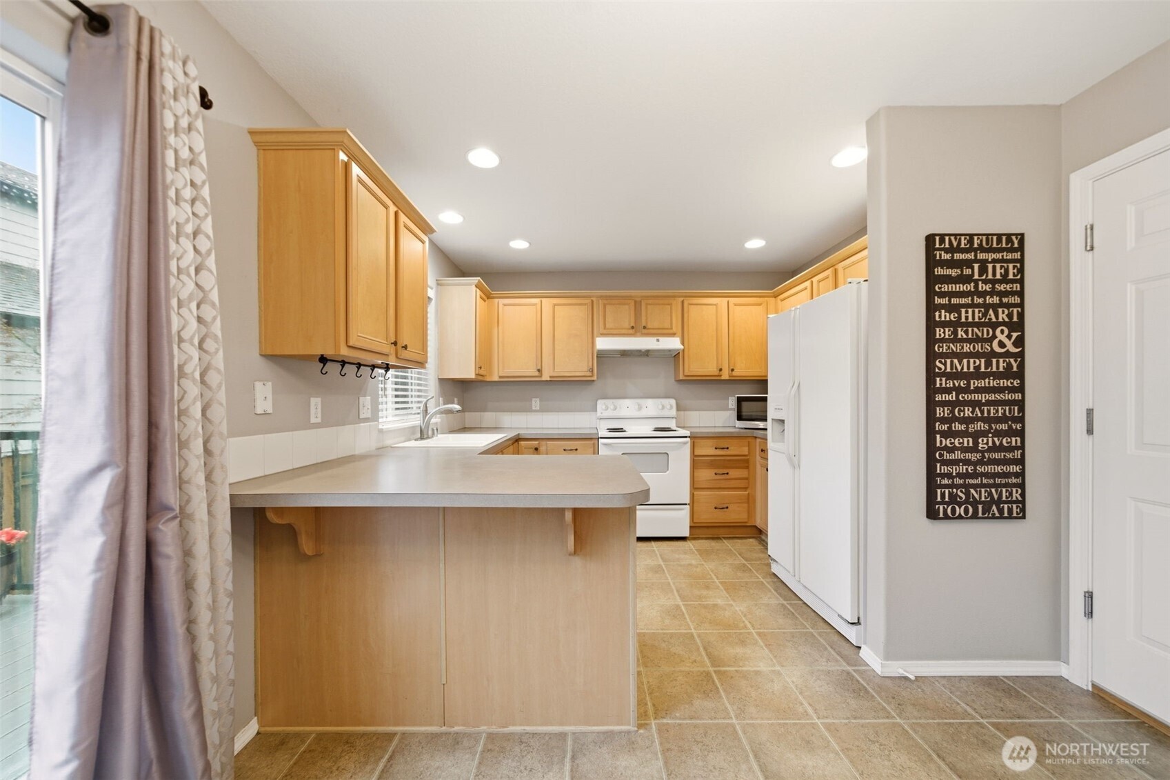 1205 Northeast 165th Way Ridgefield, WA 98642 - Photo 14 of 38 a kitchen with a sink window and cabinets