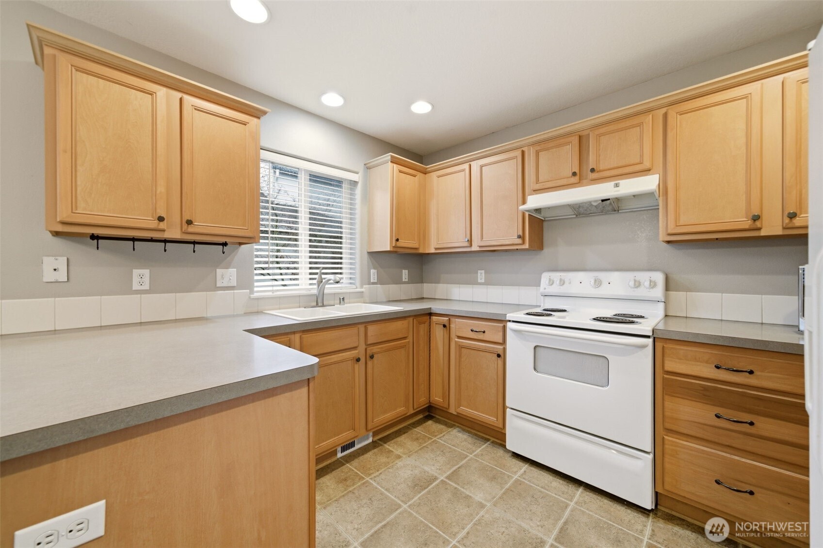 1205 Northeast 165th Way Ridgefield, WA 98642 - Photo 16 of 38 a kitchen with granite countertop cabinets stainless steel appliances and a sink
