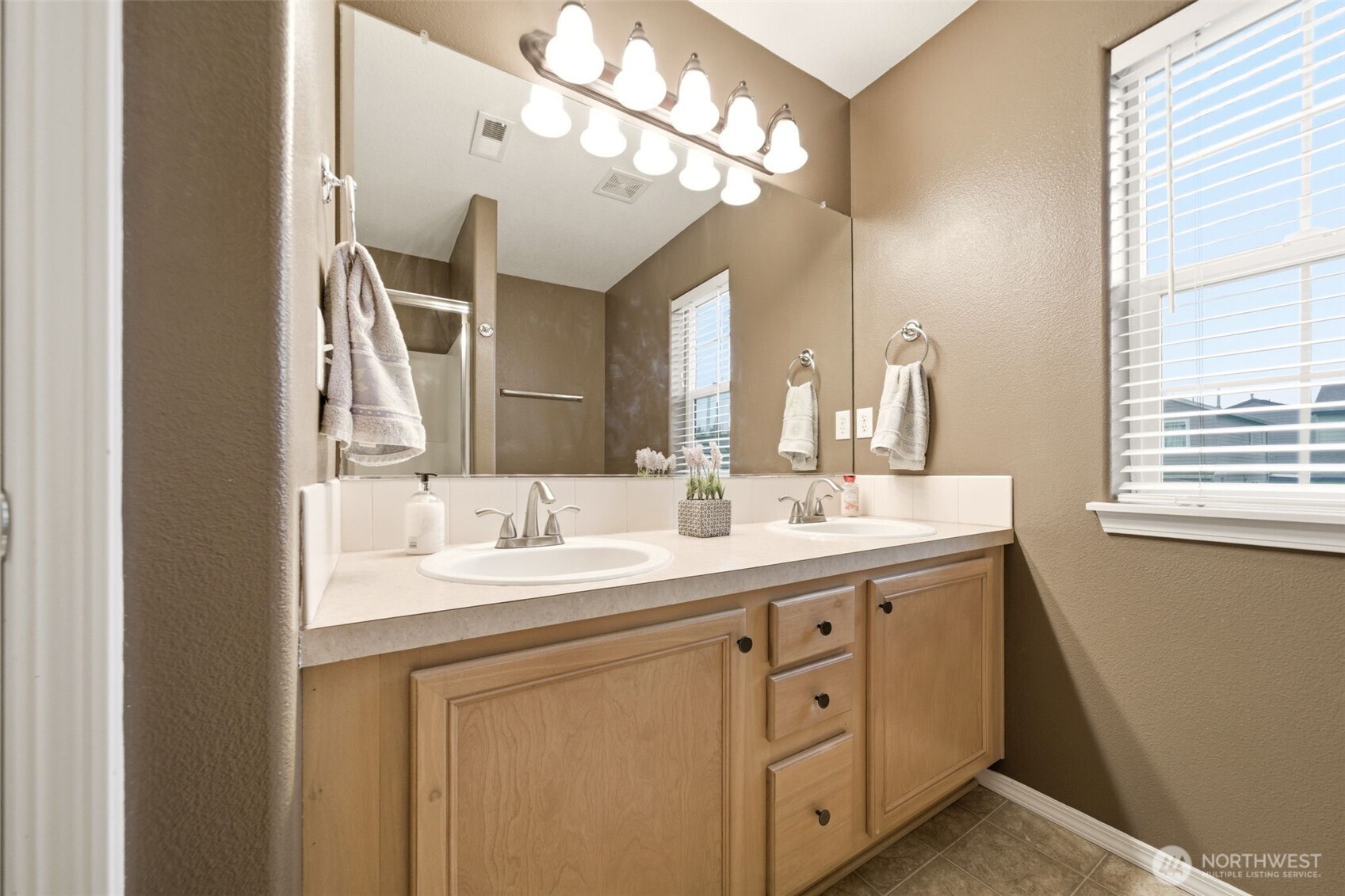 1205 Northeast 165th Way Ridgefield, WA 98642 - Photo 23 of 38 a bathroom with a double vanity sink and a mirror