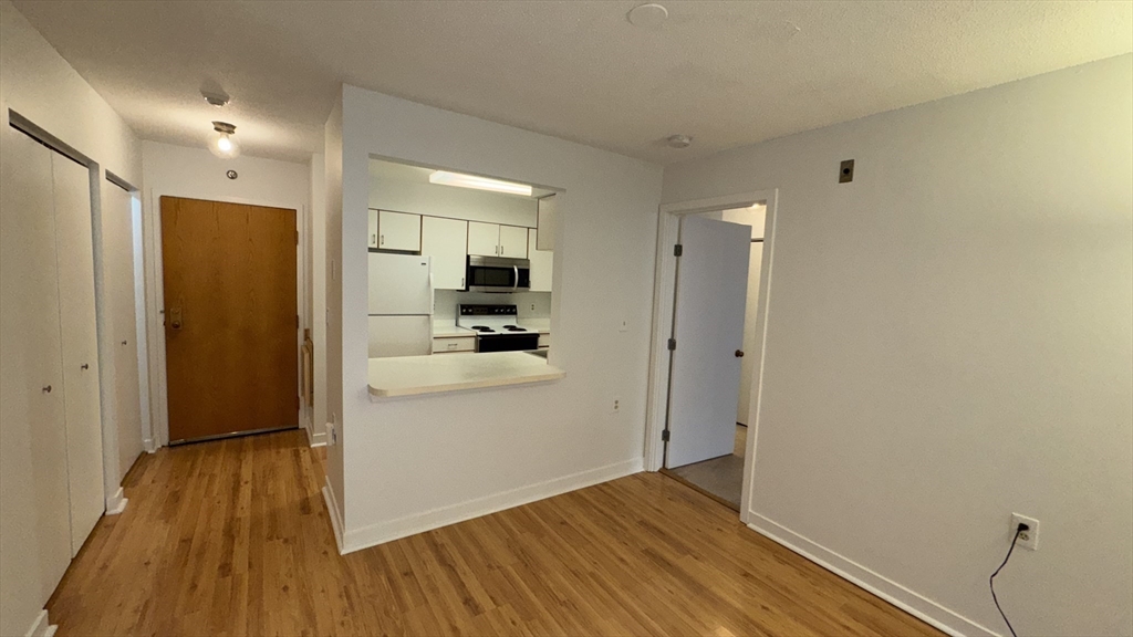 100 Rosemary Way, Unit 129 Needham, MA 02494 - Photo 8 of 20 a view of hallway with wooden floor