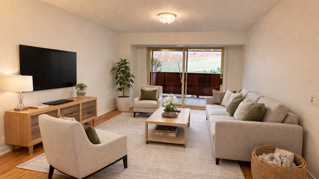 100 Rosemary Way, Unit 129 Needham, MA 02494 - Photo 10 of 20 a living room with furniture and a flat screen tv