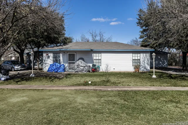 a view of a house with a yard and a garage