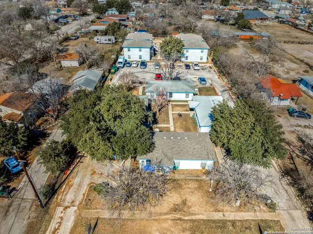 an aerial view of residential houses with outdoor space