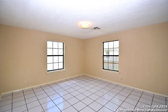 an empty room with windows and closet