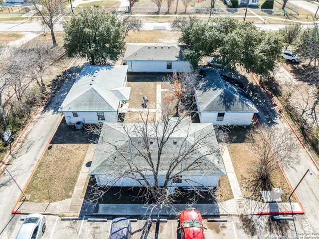 an aerial view of a house with a yard