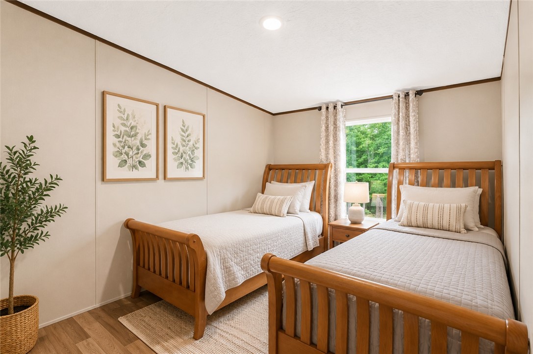 101 Drucker Ridge Anderson, SC 29625 - Photo 16 of 20 A naturally illuminated bedroom offers wood-toned flooring and recessed ceiling lights for a calming retreat.