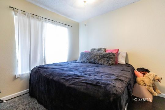 420 Montefino Drive Ridgecrest, CA 93555 - Photo 25 of 38 a bedroom with a bed and a window