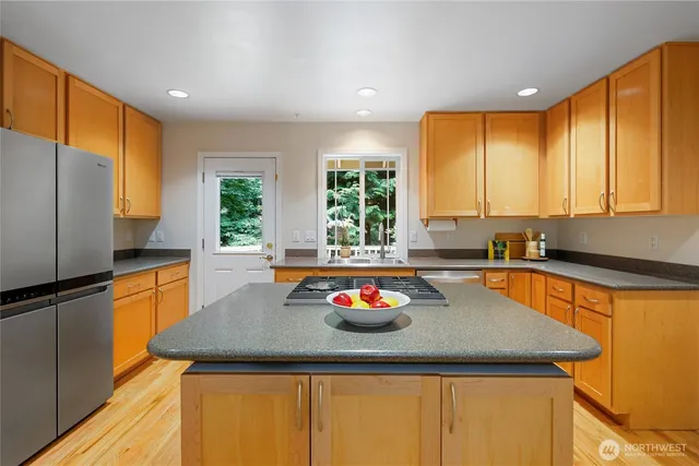 a kitchen with a sink a stove and a refrigerator
