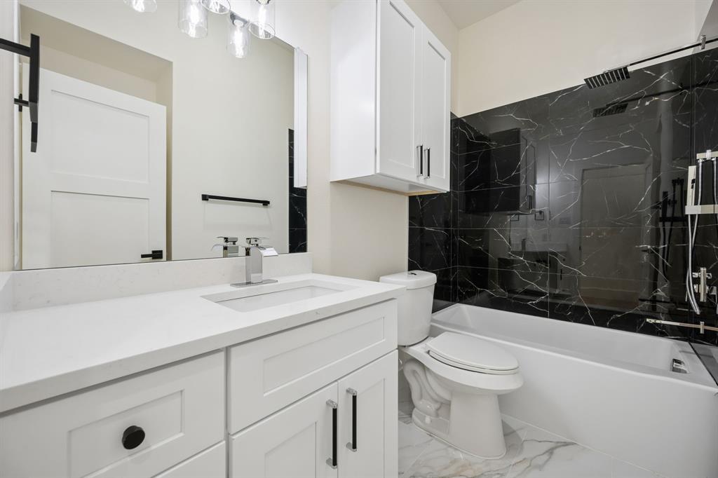 105 Buckboard Trail Oak Point, TX 75068 - Photo 18 of 27 Bathroom featuring vanity and gorgeous shower wall and floor surfaces.