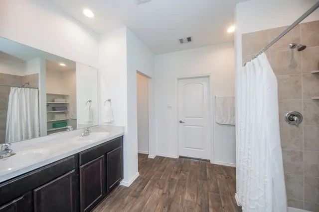 a bathroom with a double vanity sink and a mirror