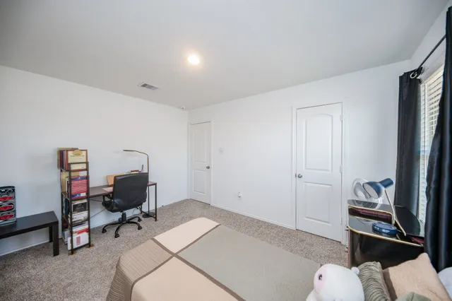 a bedroom with a workspace