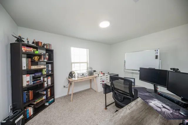 a workspace with furniture bookshelf and a window