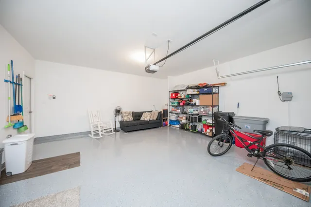 a view of a garage with a bike and white walls