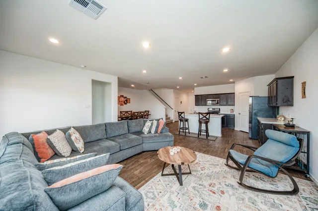 a living room with furniture and kitchen view