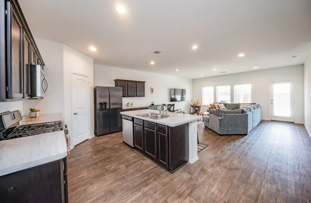 a kitchen with stainless steel appliances granite countertop a stove and a refrigerator