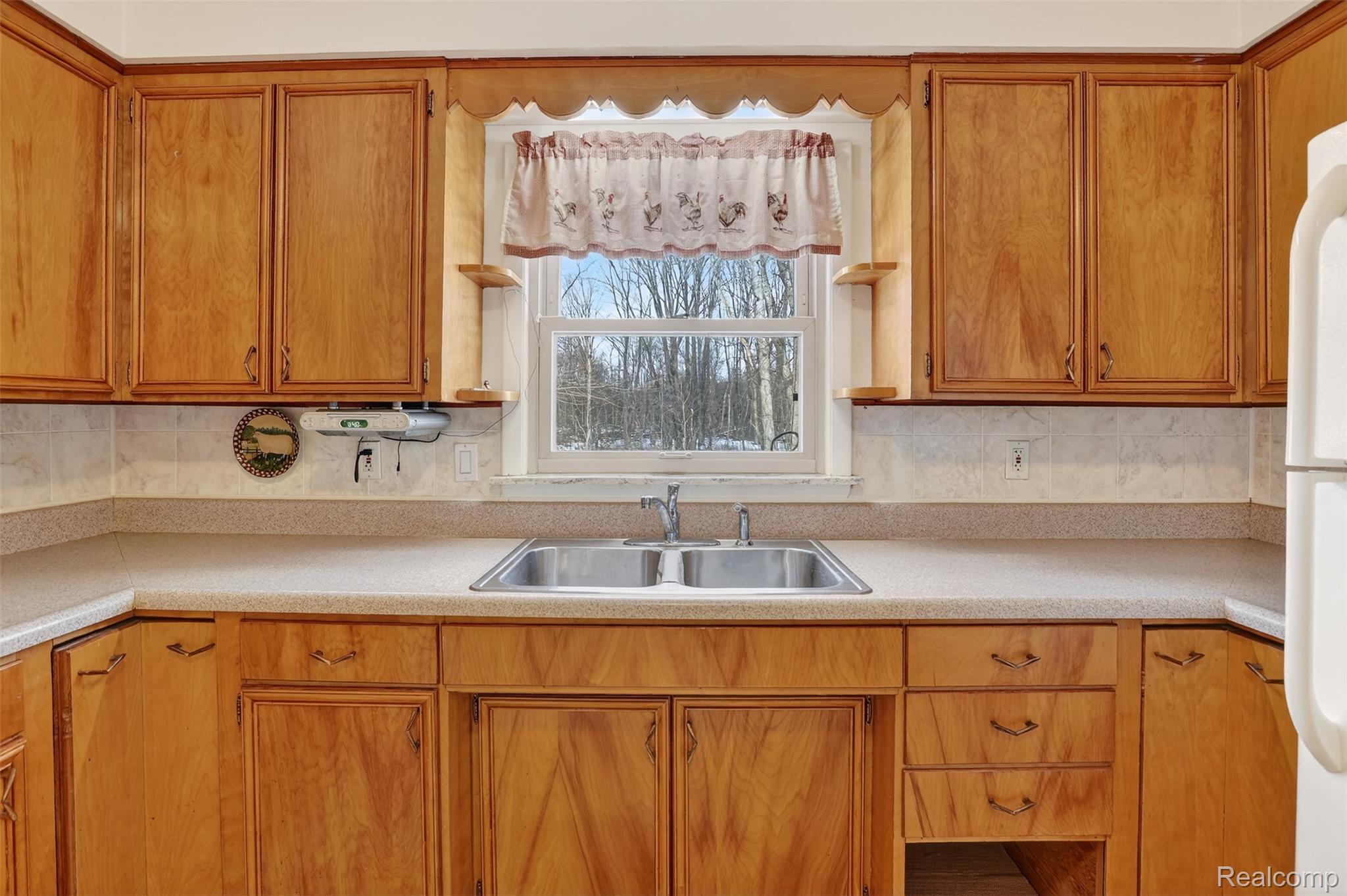 3241 Curtis Road Birch Run, MI 48415 - Photo 19 of 47 Kitchen with light countertops and brown cabinetry