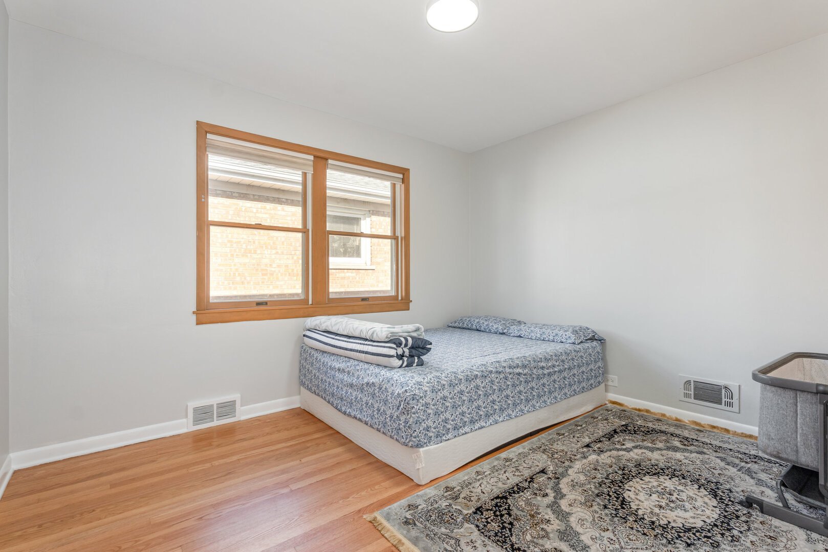 8108 North Overhill Avenue Niles, IL 60714 - Photo 11 of 18 a bed sitting in a bedroom next to a window