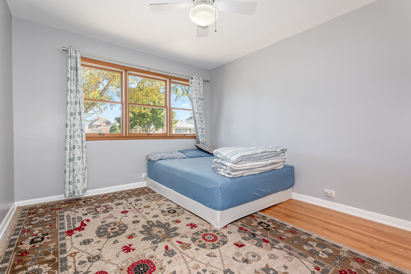 8108 North Overhill Avenue Niles, IL 60714 - Photo 12 of 18 a living room with a bed and a window