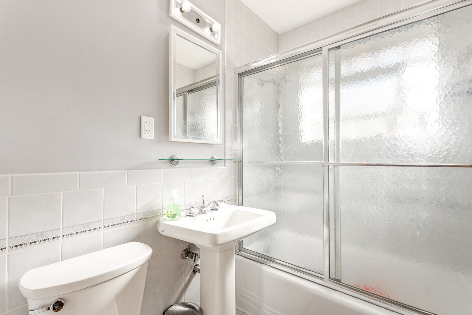 8108 North Overhill Avenue Niles, IL 60714 - Photo 7 of 18 a bathroom with a sink toilet and shower