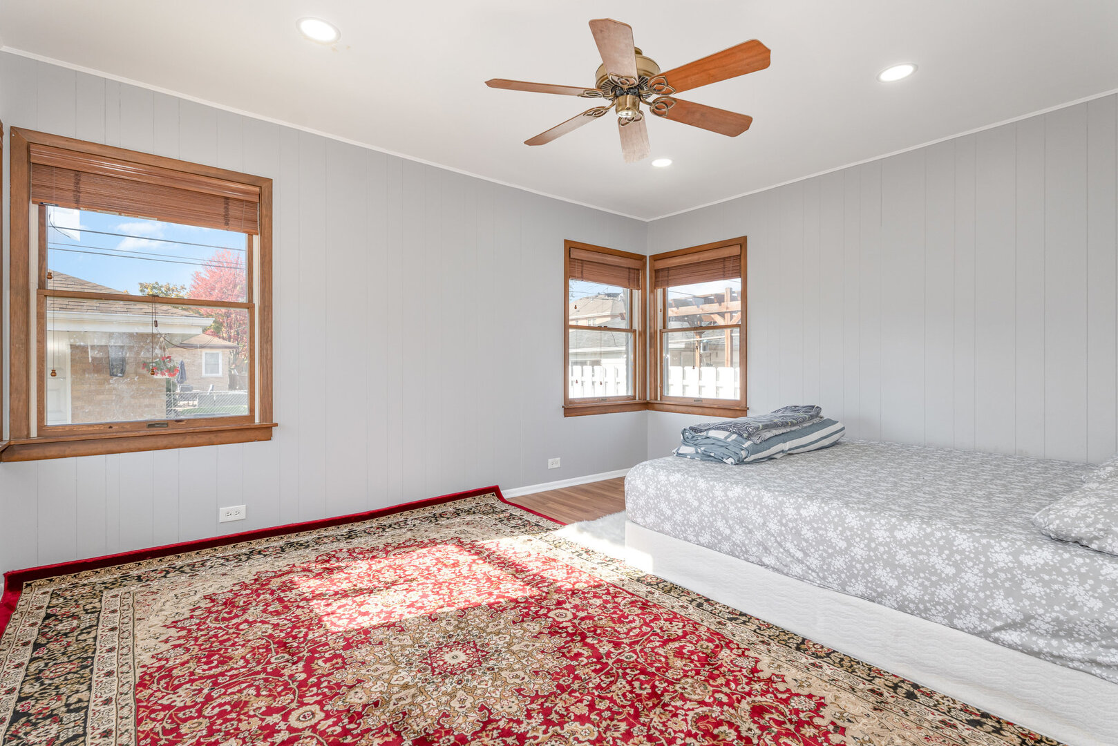 8108 North Overhill Avenue Niles, IL 60714 - Photo 9 of 18 a bedroom with a large bed with wooden floor next to a window