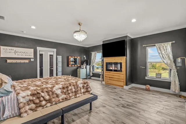 a bedroom with a large bed and windows