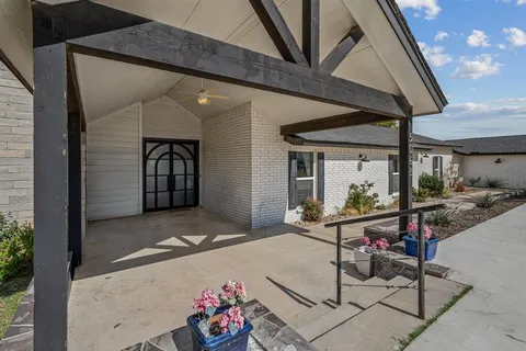 a view of a patio with table and chairs and potted plants
