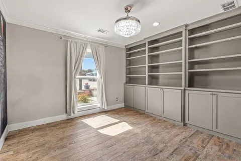 a bedroom with a bed and a flat tv screen on the dresser