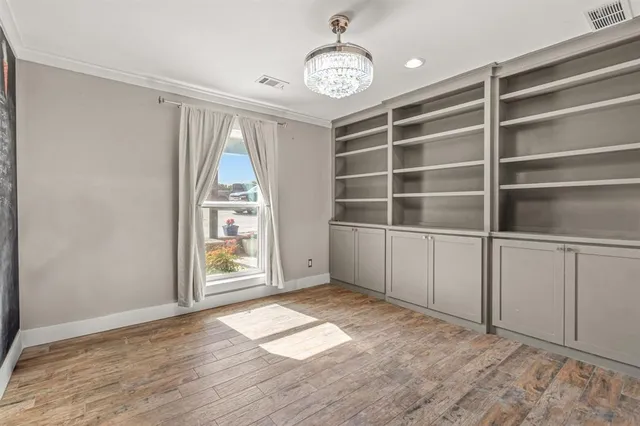 a bedroom with a bed and a flat tv screen on the dresser