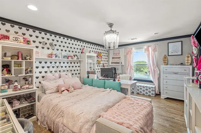 a view of an empty room with furniture and wooden floor