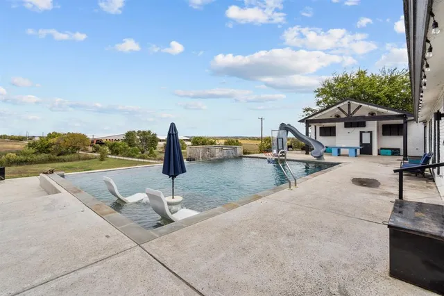 a view of a patio with swimming pool