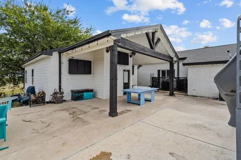 a view of a porch with furniture and a floor to ceiling window