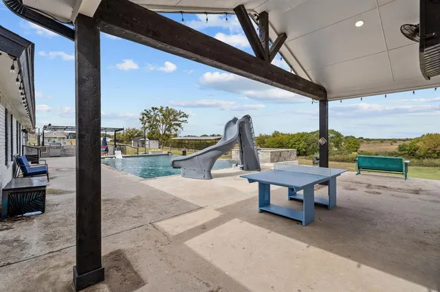 a view of a house with swimming pool and sitting area