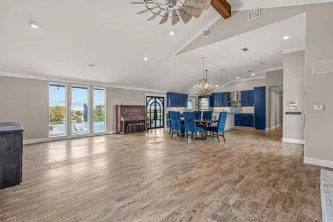 a view of a livingroom with furniture wooden floor and chandelier