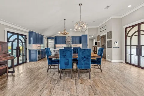 a view of a dining room with furniture wooden floor and chandelier