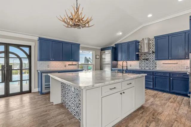 a kitchen with stainless steel appliances granite countertop a stove a sink dishwasher and a refrigerator