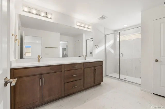 a spacious bathroom with a double vanity sink mirror and double