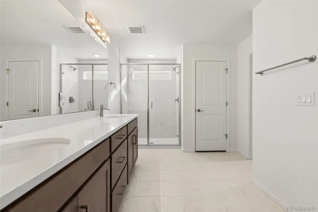 a spacious bathroom with a granite countertop sink and a mirror