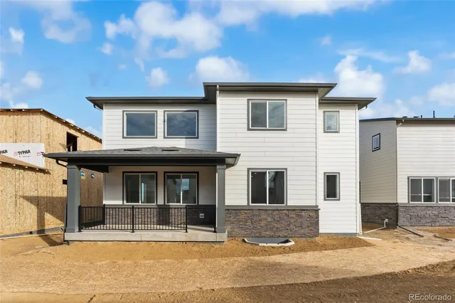 a view of a white house with large windows