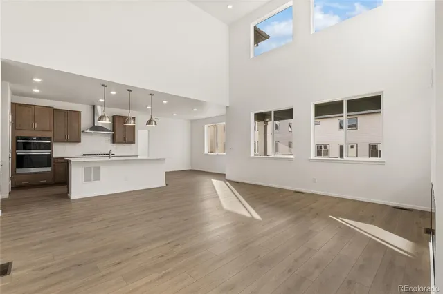 a view of kitchen with wooden floor and windows