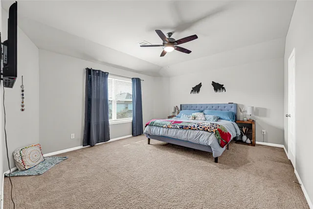 a bedroom with a bed and window