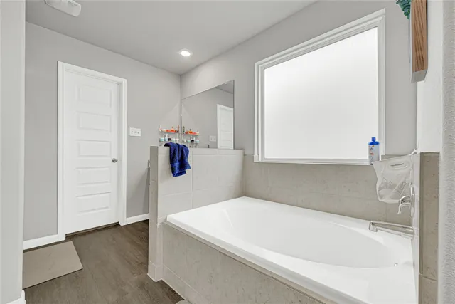 a bathroom with a tub and shower