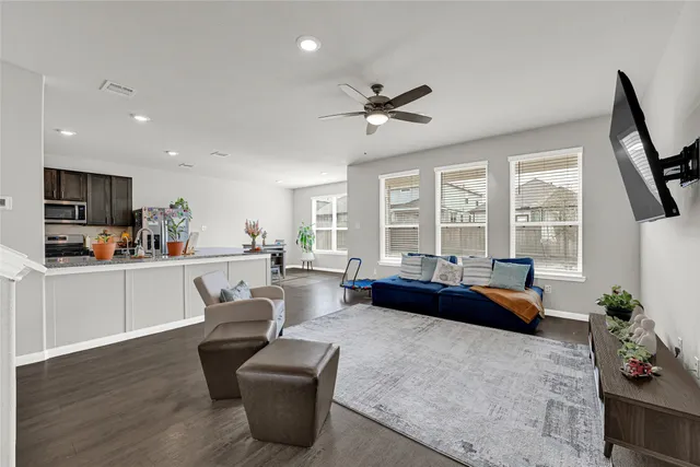 a living room with furniture and a large window