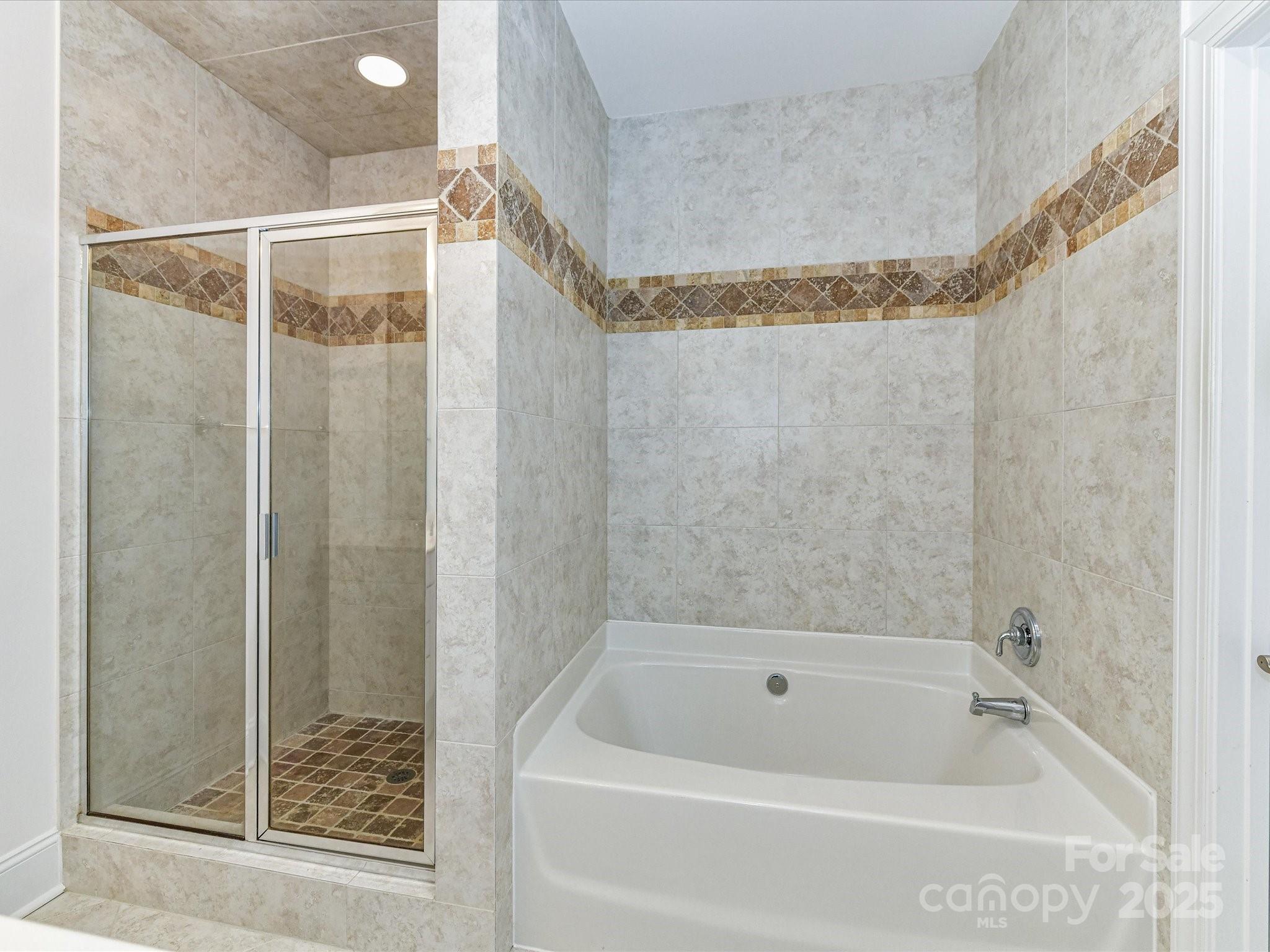 155 Harper Lee Street Davidson, NC 28036 - Photo 16 of 26 a bathroom with a bathtub and shower