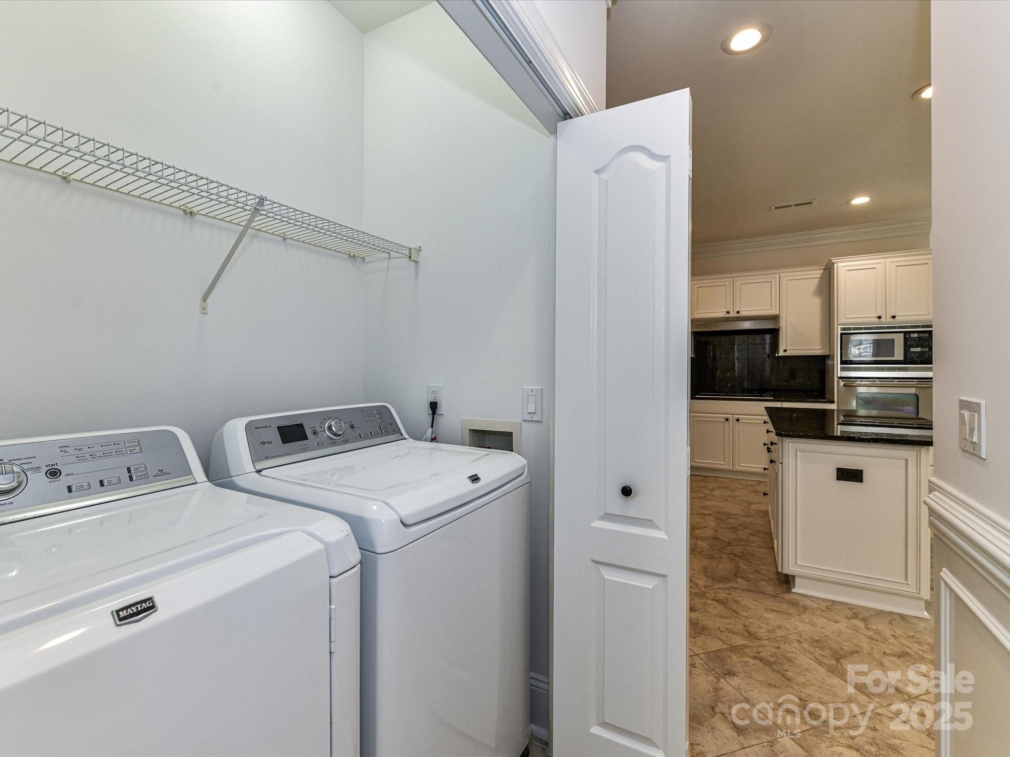155 Harper Lee Street Davidson, NC 28036 - Photo 18 of 26 a view of washer and dryer with kitchen view
