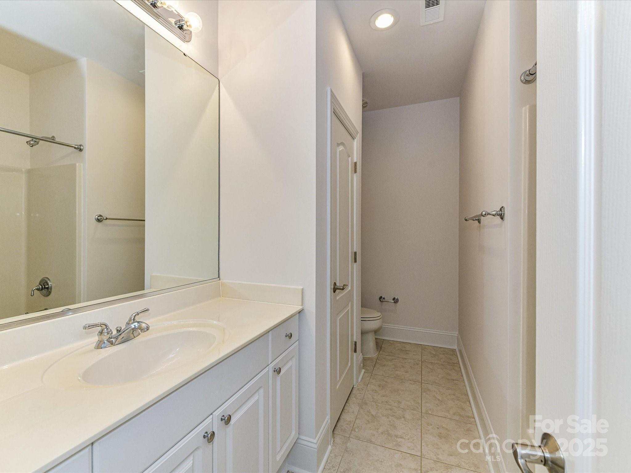 155 Harper Lee Street Davidson, NC 28036 - Photo 22 of 26 a bathroom with a sink and a mirror